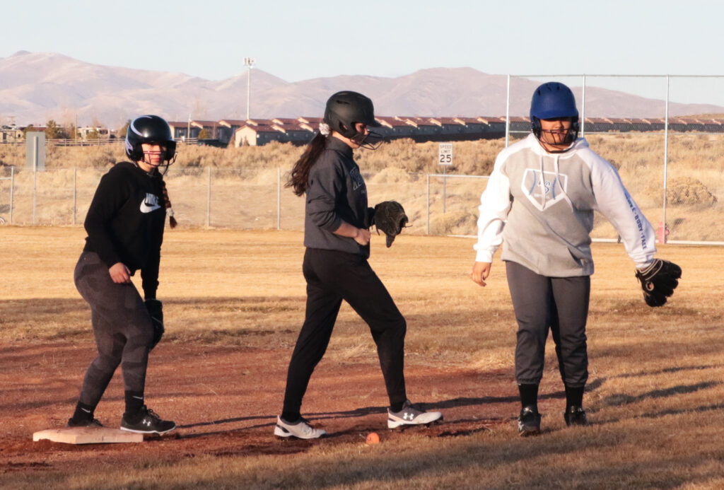 JV softball players running drills./Ron Espinola • The Brand