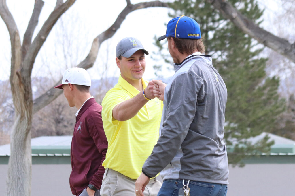 Kobe Stoker and coach Andrew Meyer share a moment together./Mackie Grady • The Brand