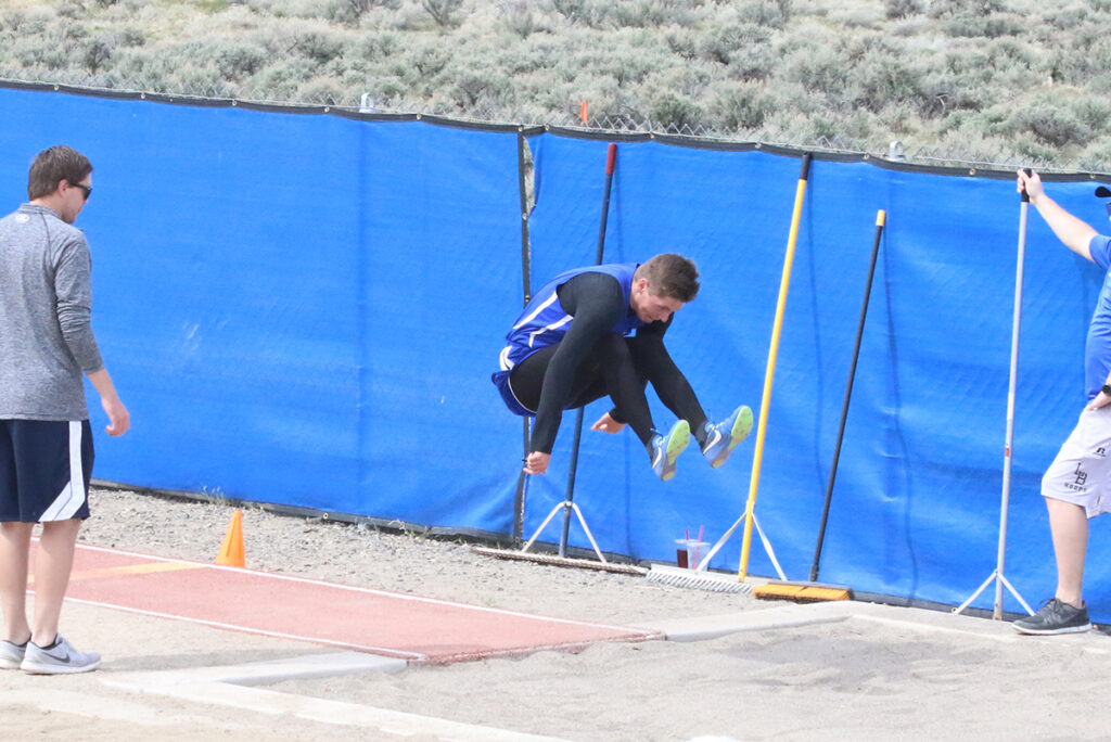 Austin Nelsen competes in the long jump./ Clarissa Olson • The Brand