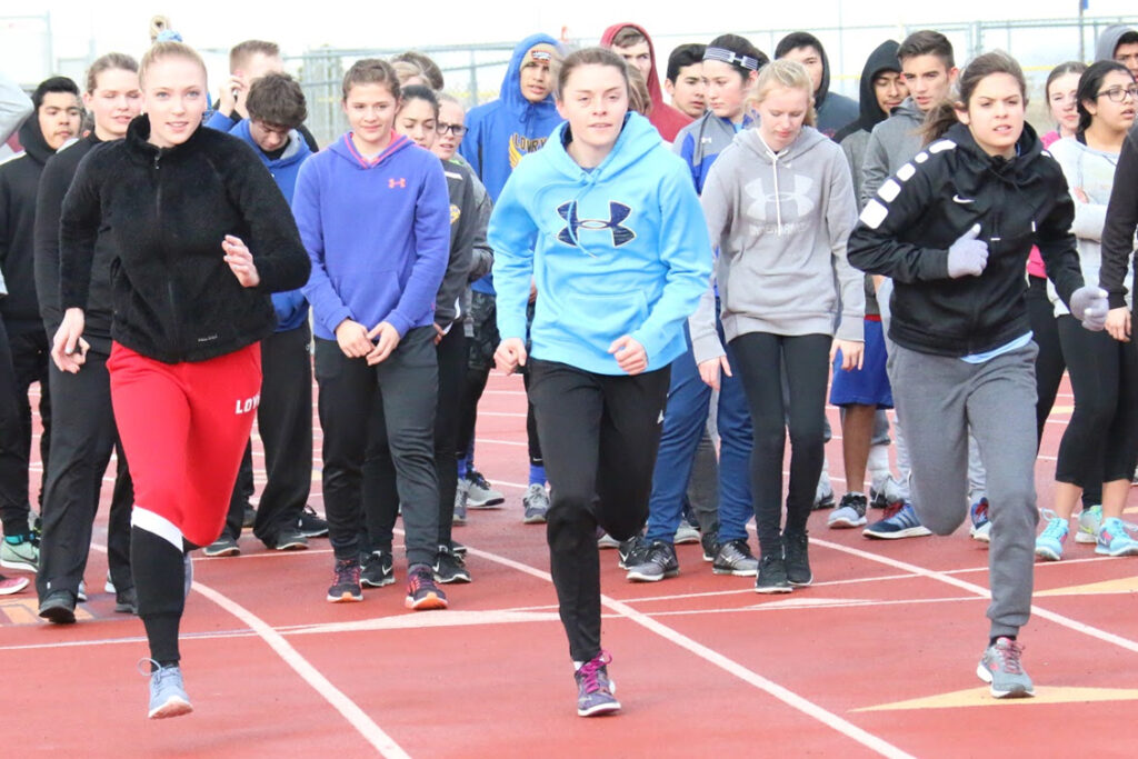 Hailey Hinkle (left), Shelby Garrison (middle), and Adia Bengochea (right) start a sprint./ Ron Espinola • The Brand