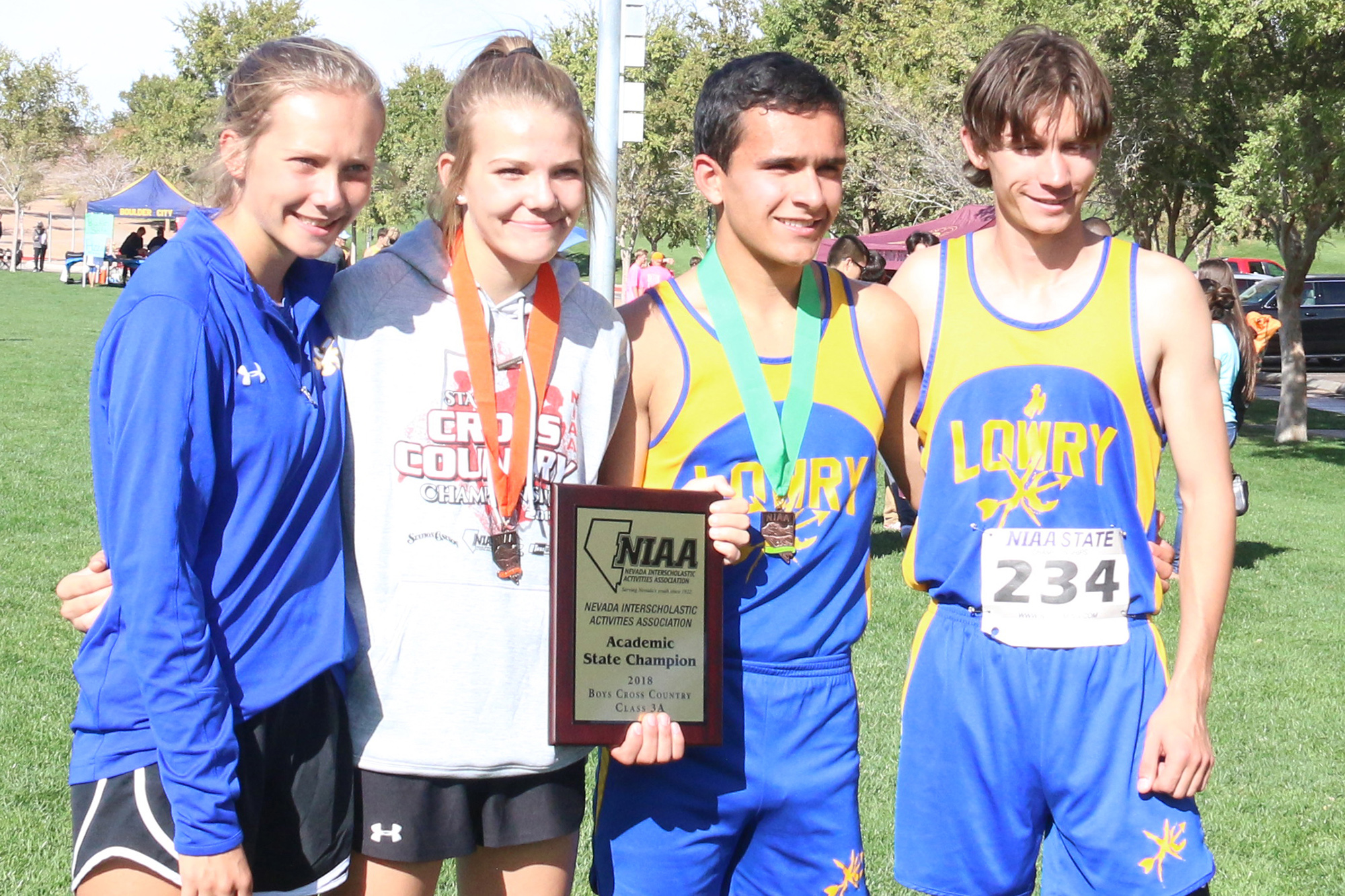 Members of the cross country team with the Academic State Championship trophy./Clarissa Olson • The Brand