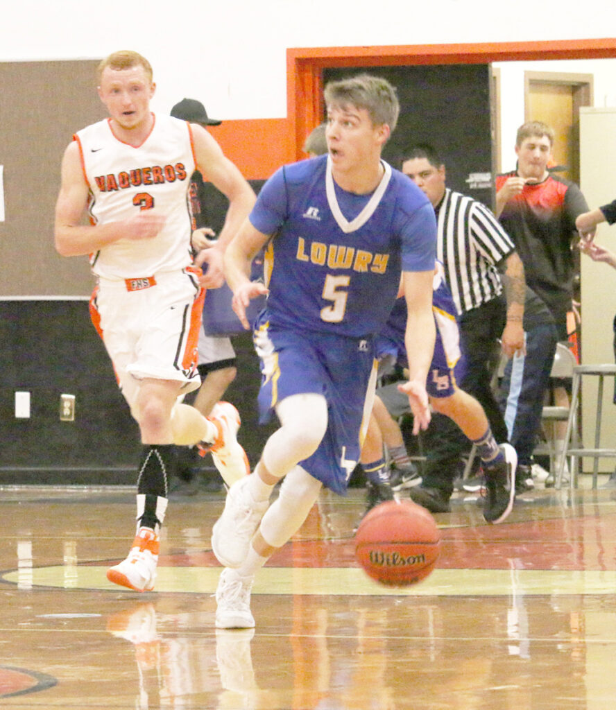 Jed Teichert brings the ball up the court./Aimee Brandon • The Brand