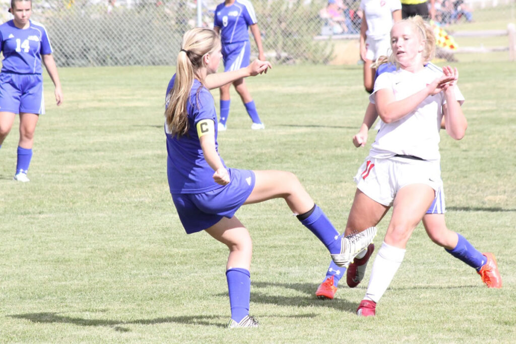 Anjolie Karrer centers the ball to a teammate./Chuckie Wiggins • The Brand