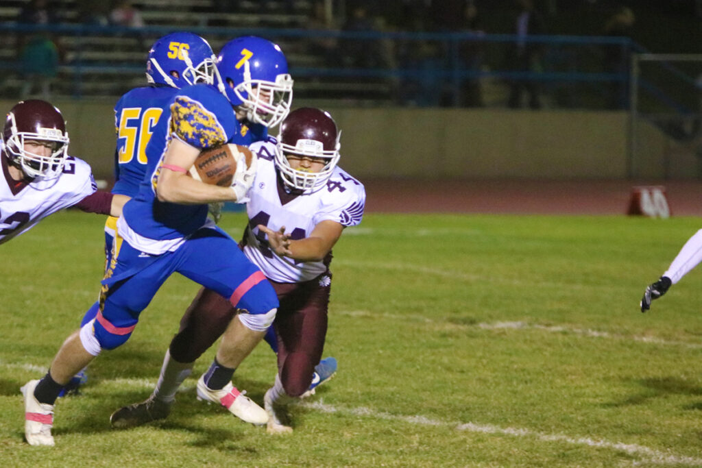 Brady Lange runs past an Elko defender./Dylan Kalkoske • The Brand