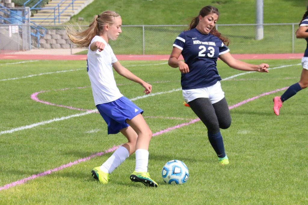Hailey Fernandez dribbles past a defender/Dylan Kalkoske • The Brand