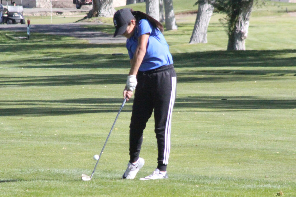 A golfer hits her approach shot./Peyton Capellen • The Brand