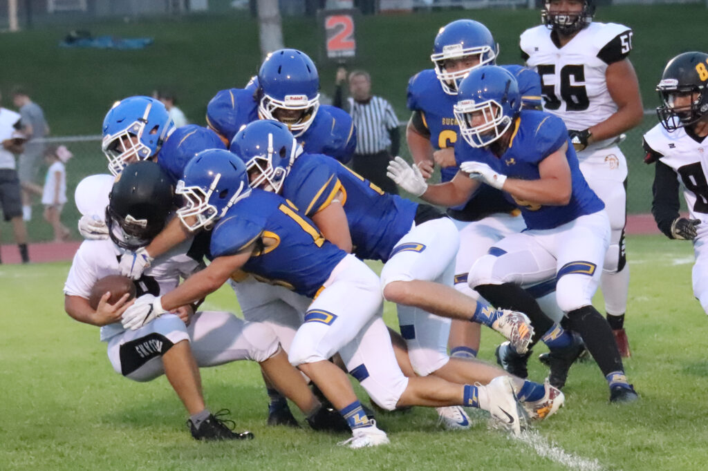 Lowry defense takes down a opponent./Ron Espinola • The Brand