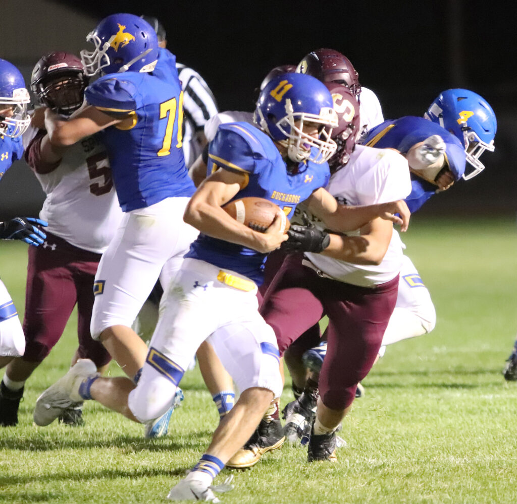 Brendan Domire tries to break a tackle./Ron Espinola • The Brand