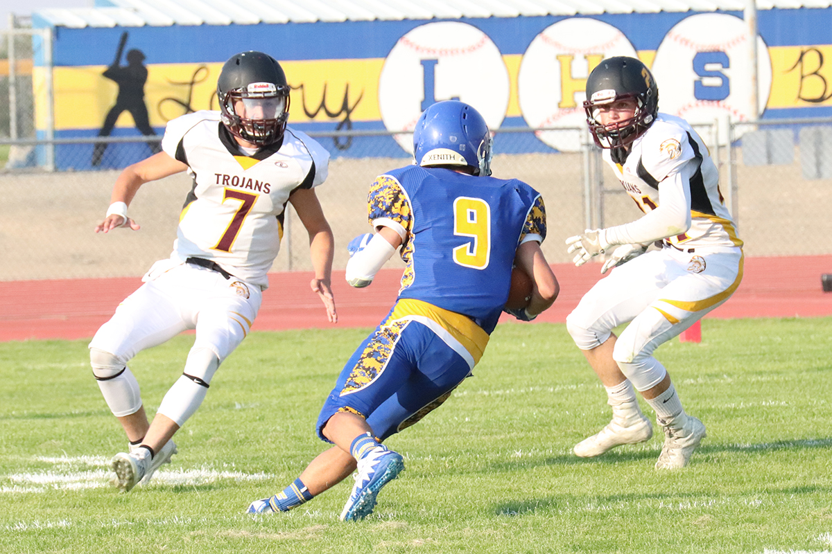 Sam Roth looks to get through the Trojan defense./ Ron Espinola • The Brand