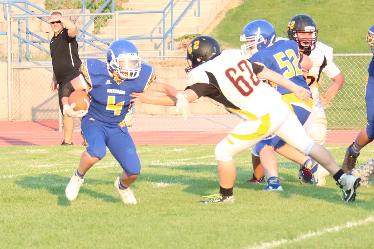 JJ Backus tries to evade the Trojans' defense./Ron Espinola• The Brand 