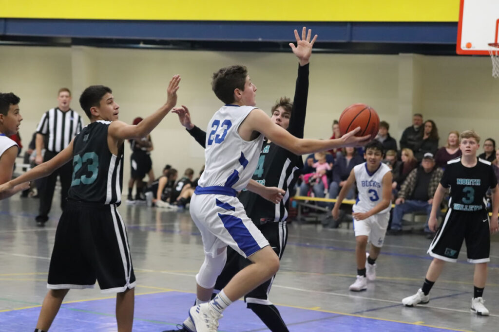 Drew Harmon gets fouled while driving to the basket./Ron Espinola • The Brand