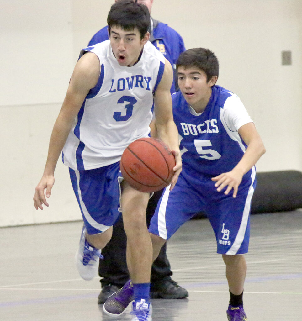 Anthony Hemp dribbles the ball with Robert Rangel in the background./Ron Espinola • The Brand