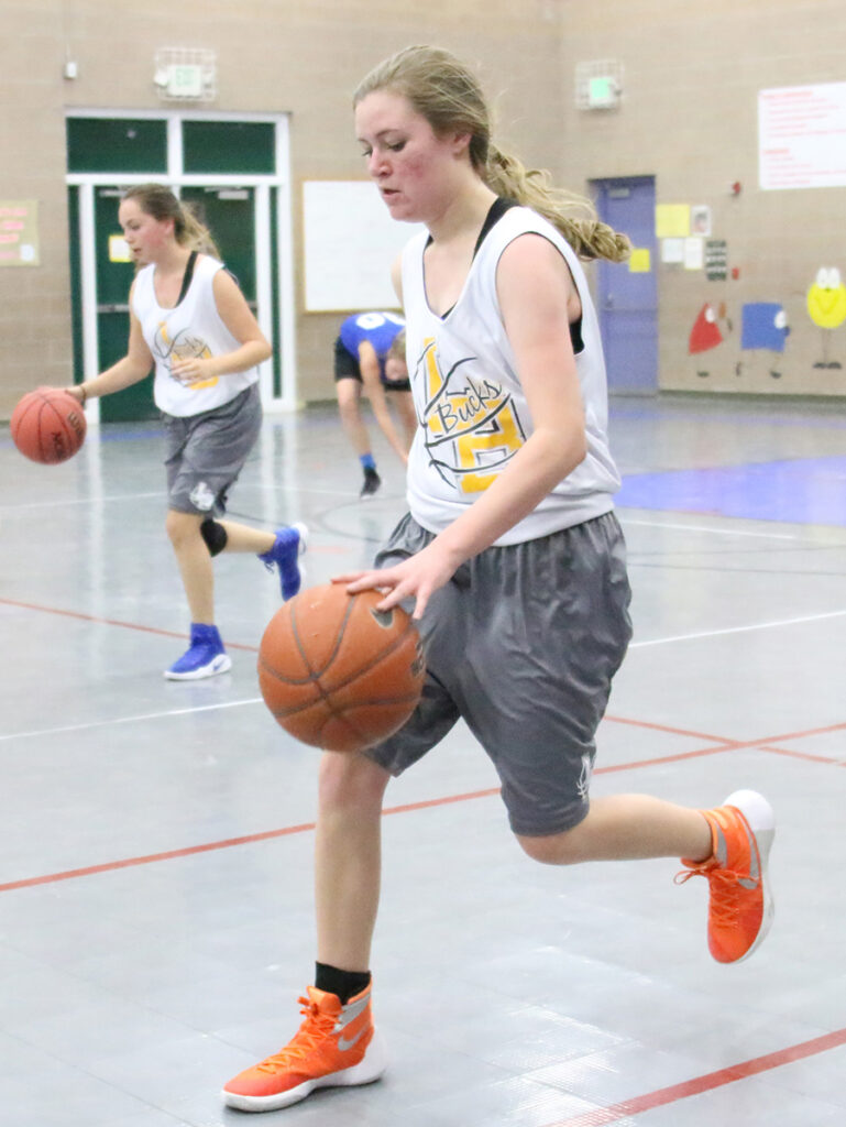 Kayla Lininger dribbles the ball down the court./Ron Espinola • The Brand