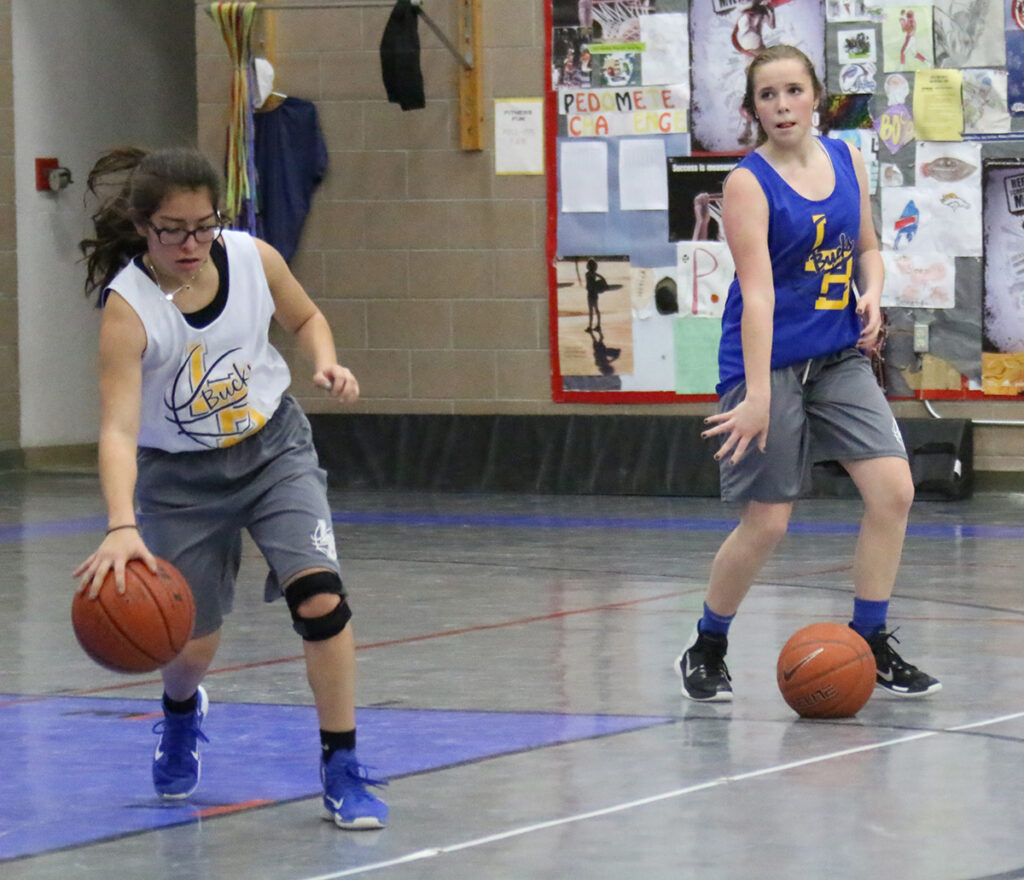 Alexus Gomez and Kayleen Urain practicice ball handling./Ron Espinola • The Brand