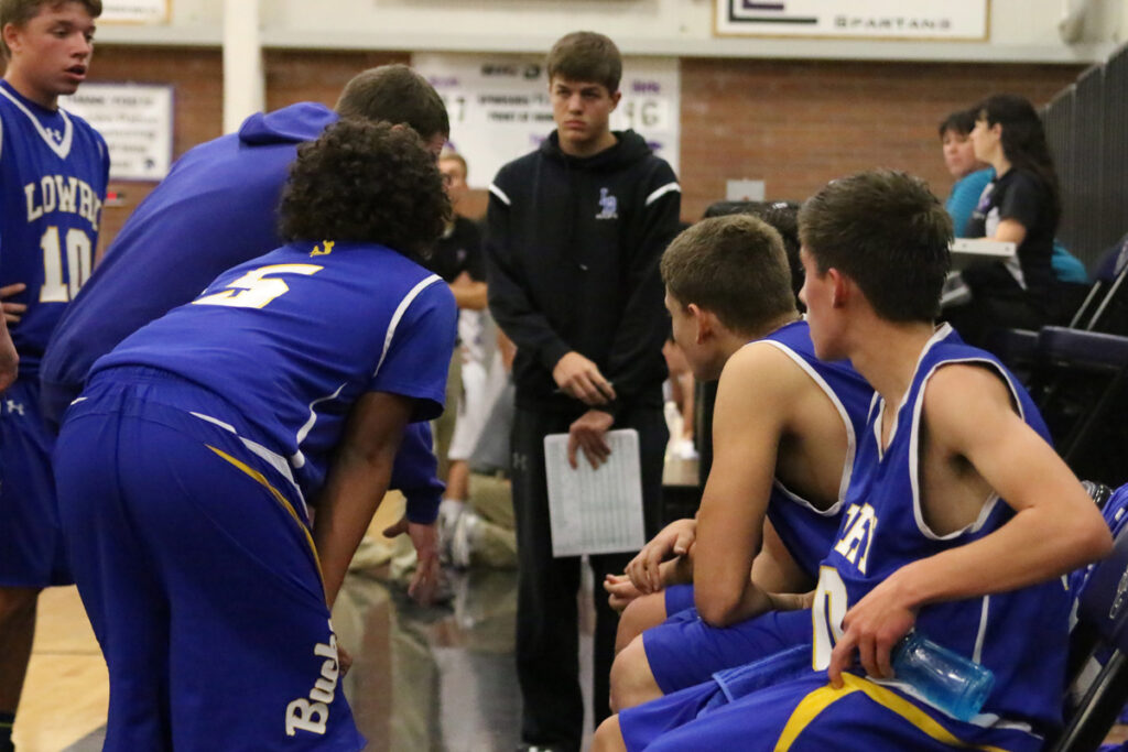 The team listens to coach Eastman during a timeout./Dylan Kalkoske