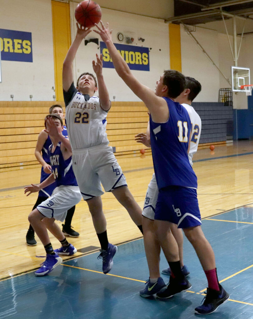 Brennan Coleman tries to block a shot by Dante Cassinelli. /Ron Espinola • The Brand