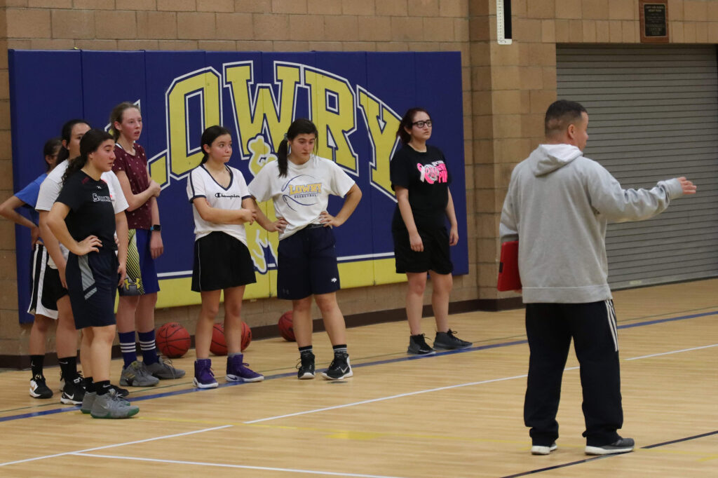 Coach Larry Renteria (R) explains a drill while the players listen. /Ron Espinola • The Brand