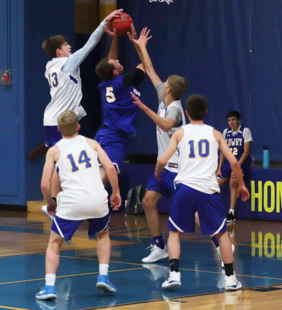 Kobe Stoker (5) gets his shot blocked by Anthony Gildone (13) and Klay Garner./Ron Espinola • The Brand