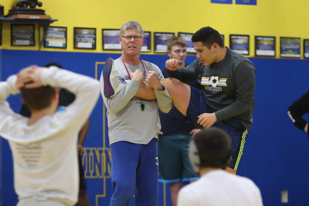 Coach John Brooks demonstrates a drill.  /Ron Espinola • The Brand