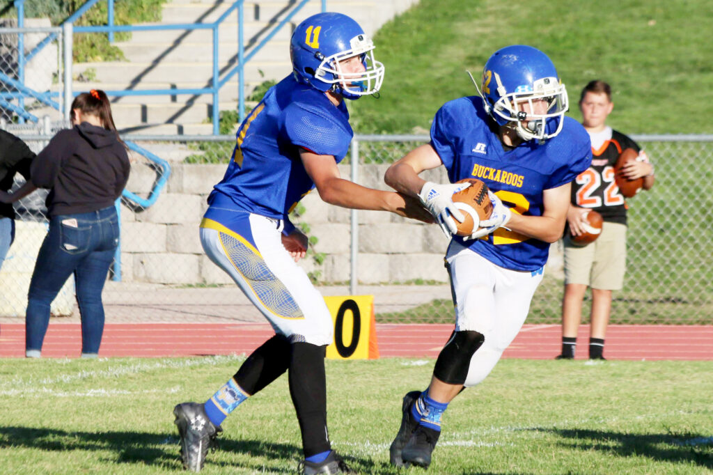 Lowry quarterback  hands off the ball to a teammate./Bree Dunckhorst • The Brand