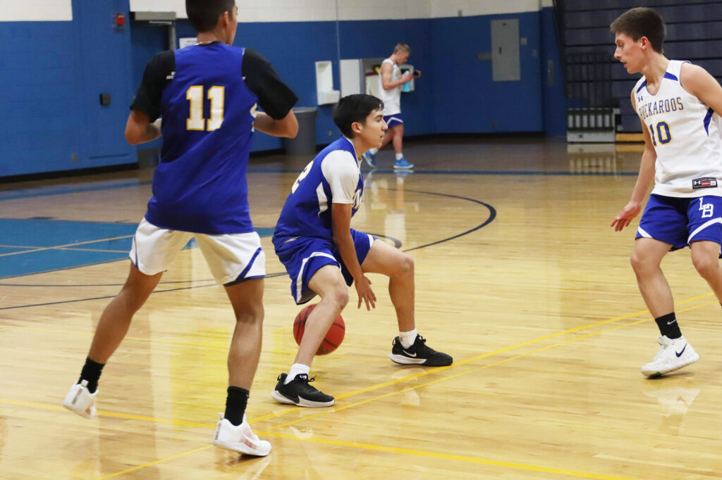  Robert Rangel does a crossover to intimidate Michael Casalez (10)/Ron Espinola • The Brand