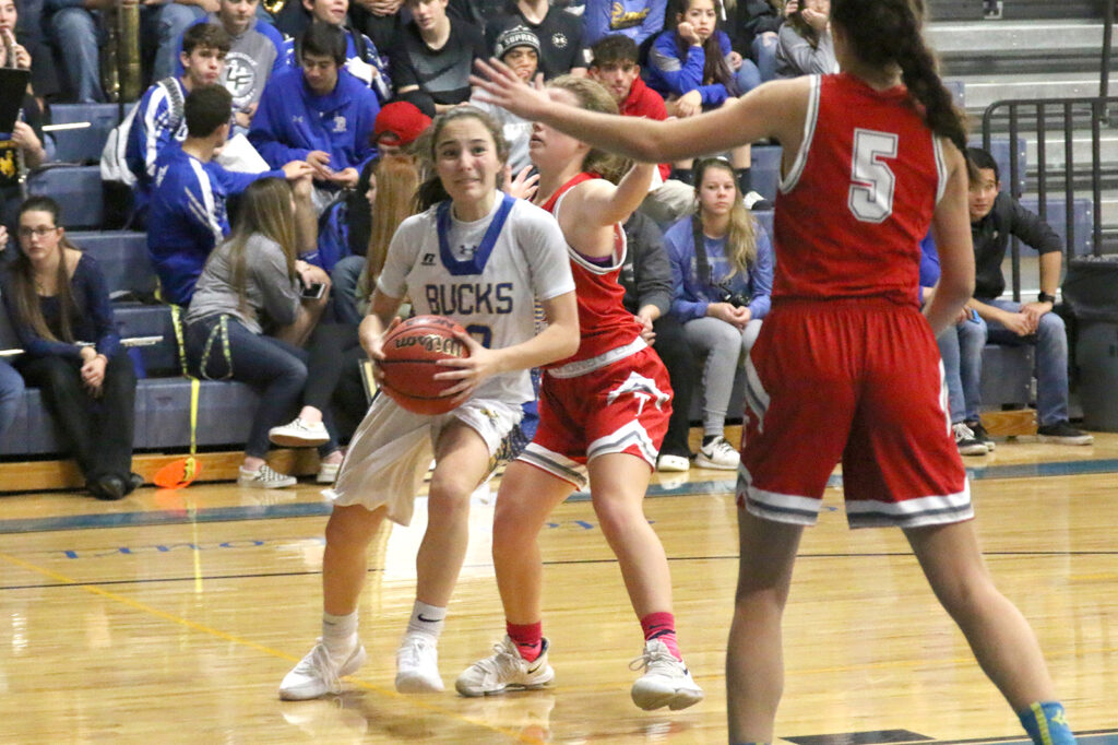 Julisa Garcia tries to get by two opponents./Ron Espinola • The Brand