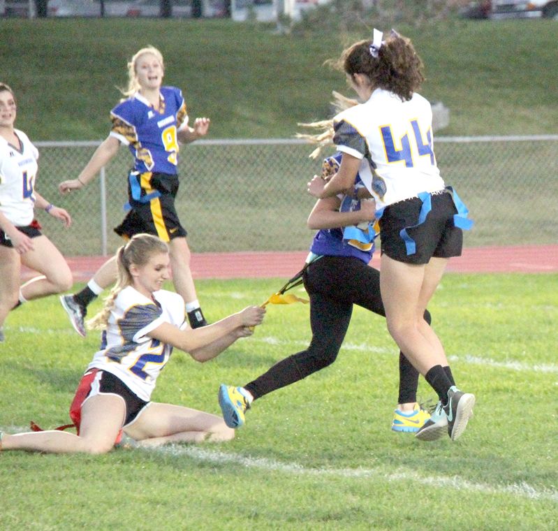 Hallie Caratzola pulls at Ashlee Barron’s illegally tied flag./Brody Goucher • The Brand