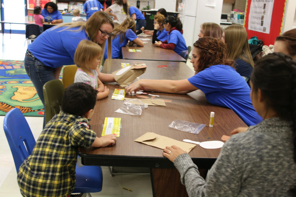 Shantell Pearrow and Chasey Bradshaw help with an activity./Kaity Sample • The Brand