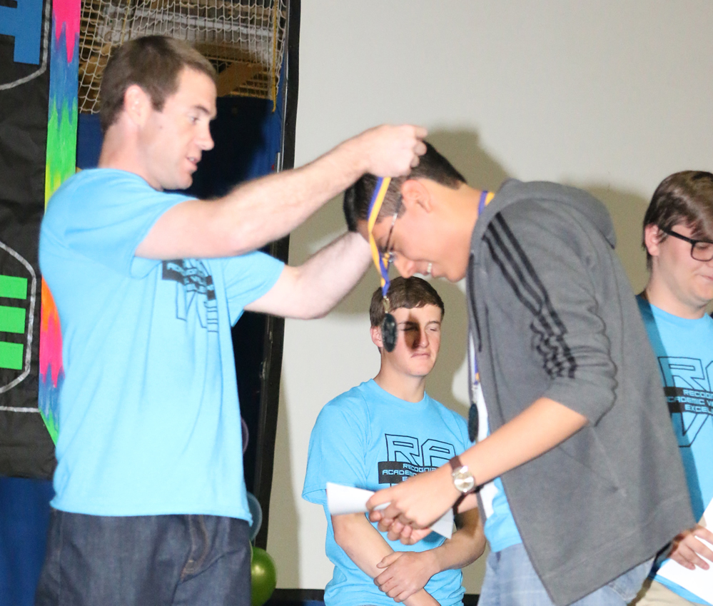 alt="Mr. Beatty places a medal upon Marcos Duran./Ron Espinola • The Brand"